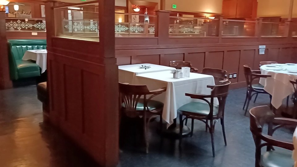 Restaurant interior with booths and polished surfaces.